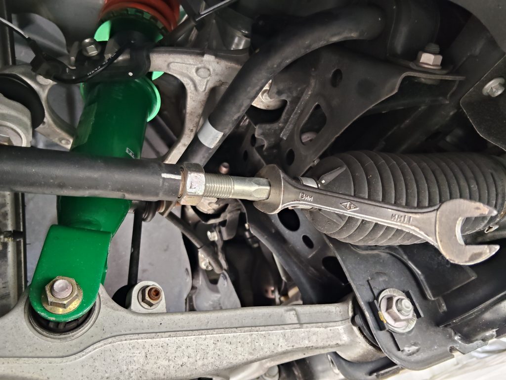 タイロッドを回してフロントのトーを調整する作業
